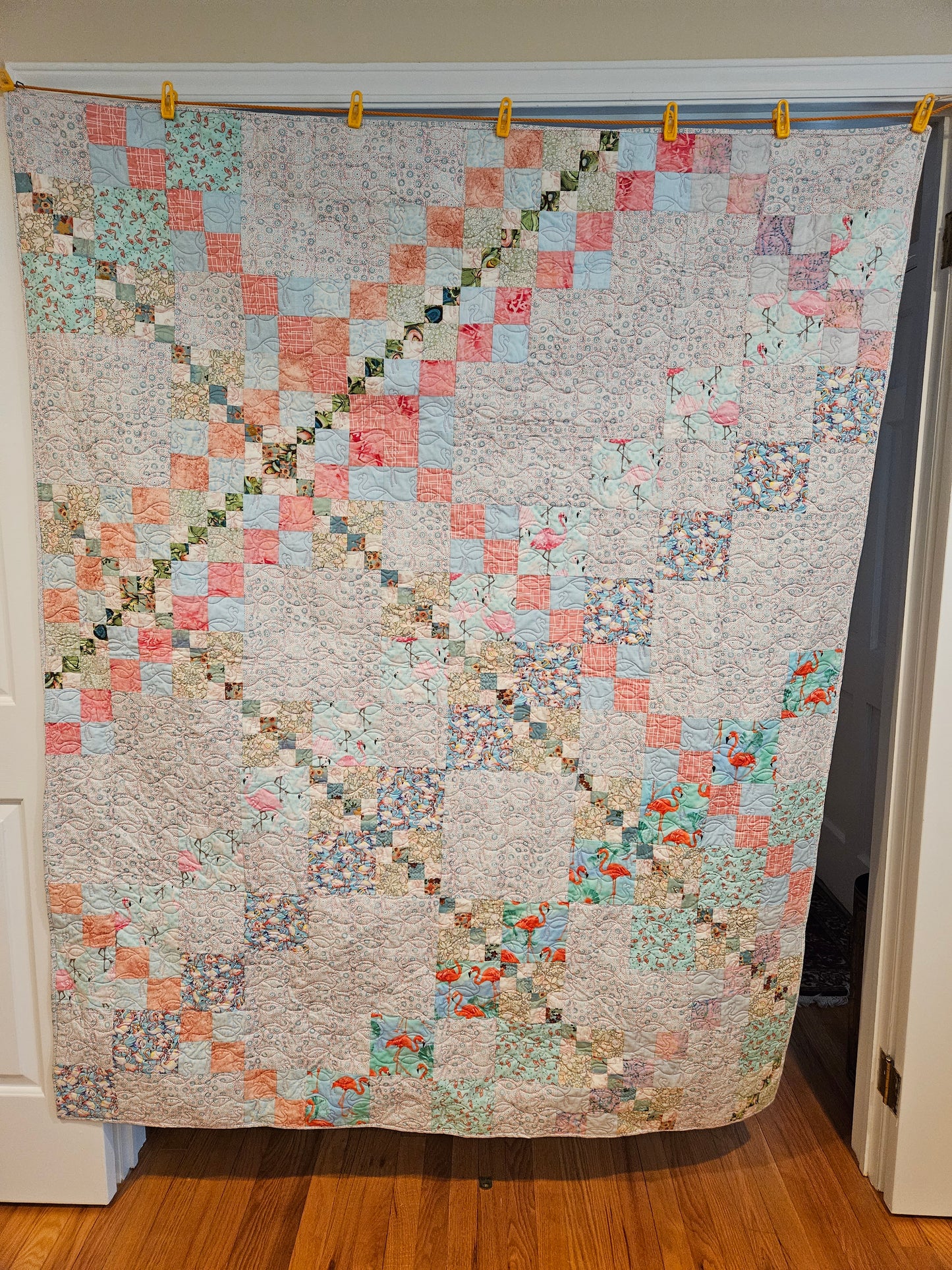 Photo showing the entire front of the blue flamingo quilt.