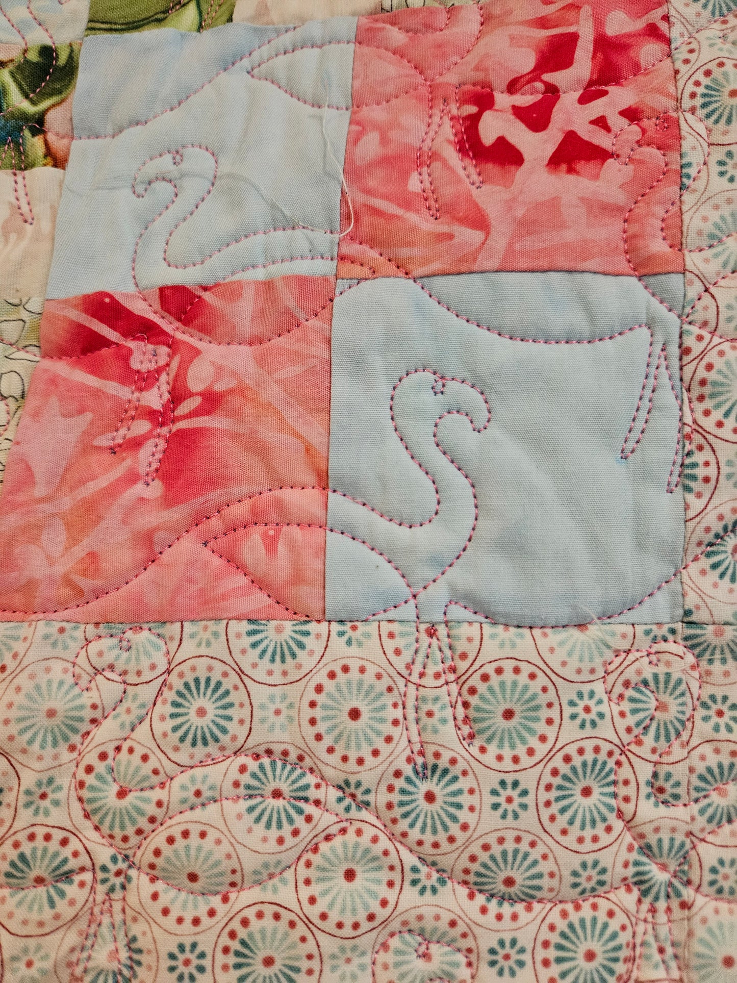 Photo shows some of the quilted flamingos on the front.