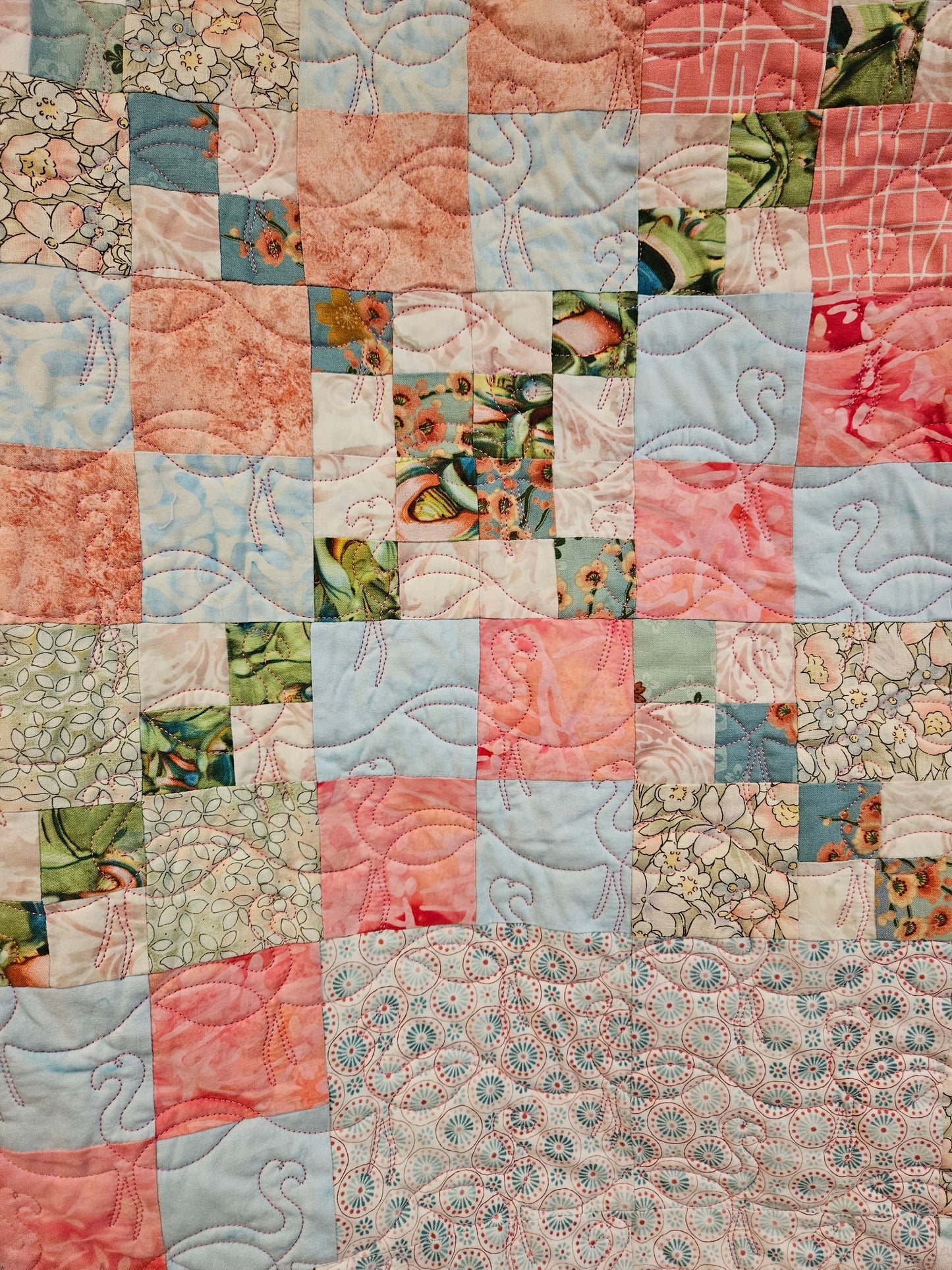 Close up of blue flamingo quilt. This is showing where the fabrics cross.