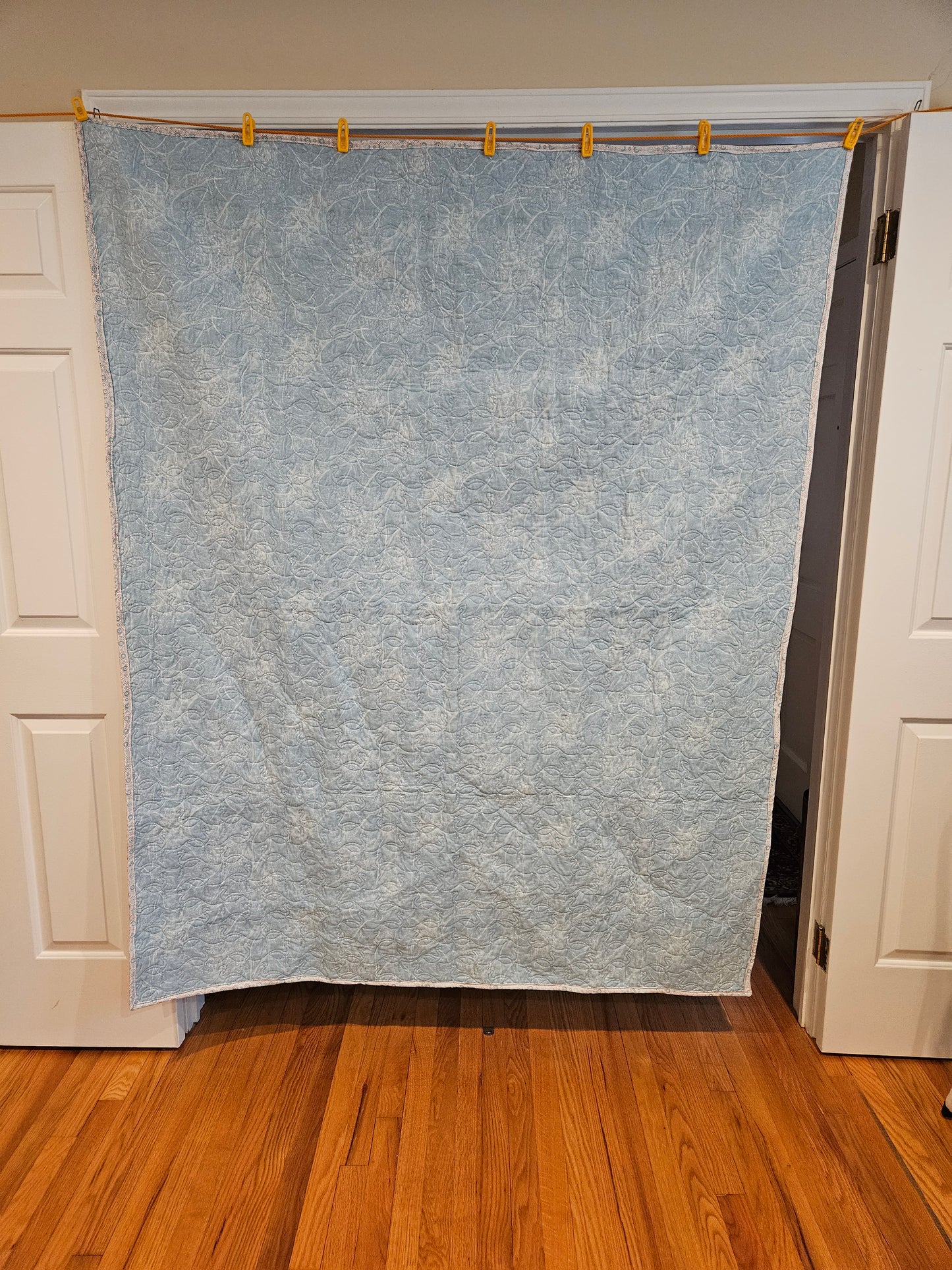 Phot showing the whole back of a flamingo quilt.