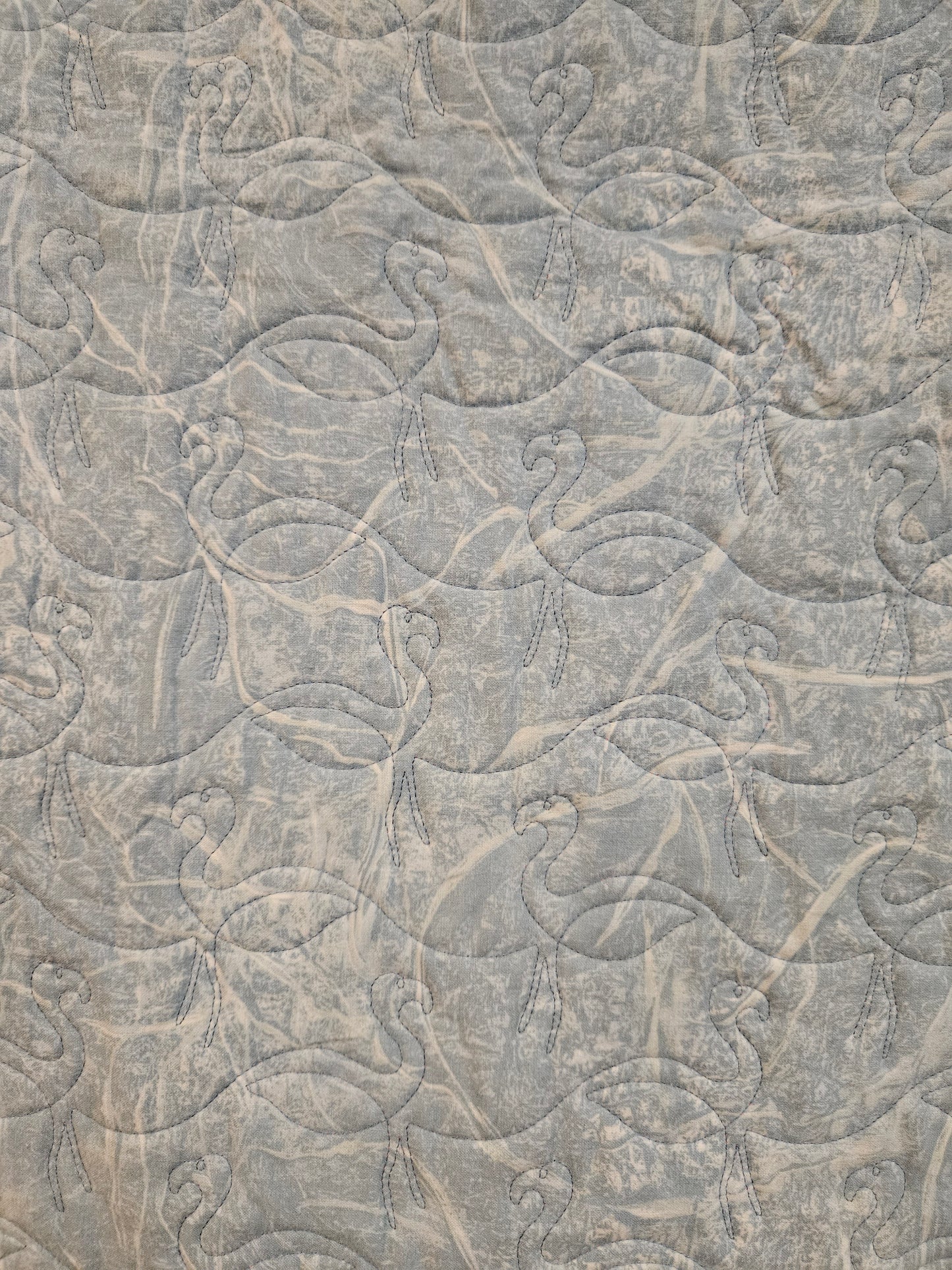Photo showing the back of a flamingo quilt.