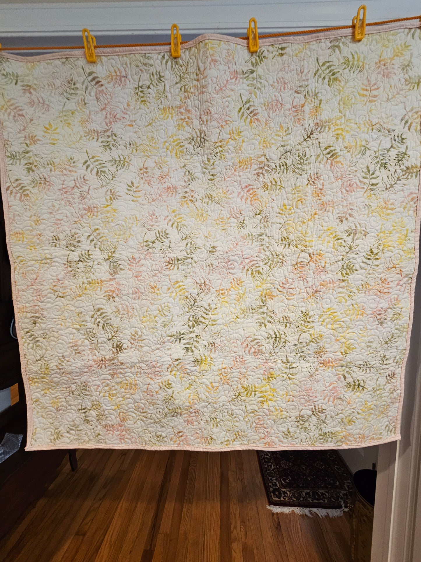 The floral pattern of the back of the quilt