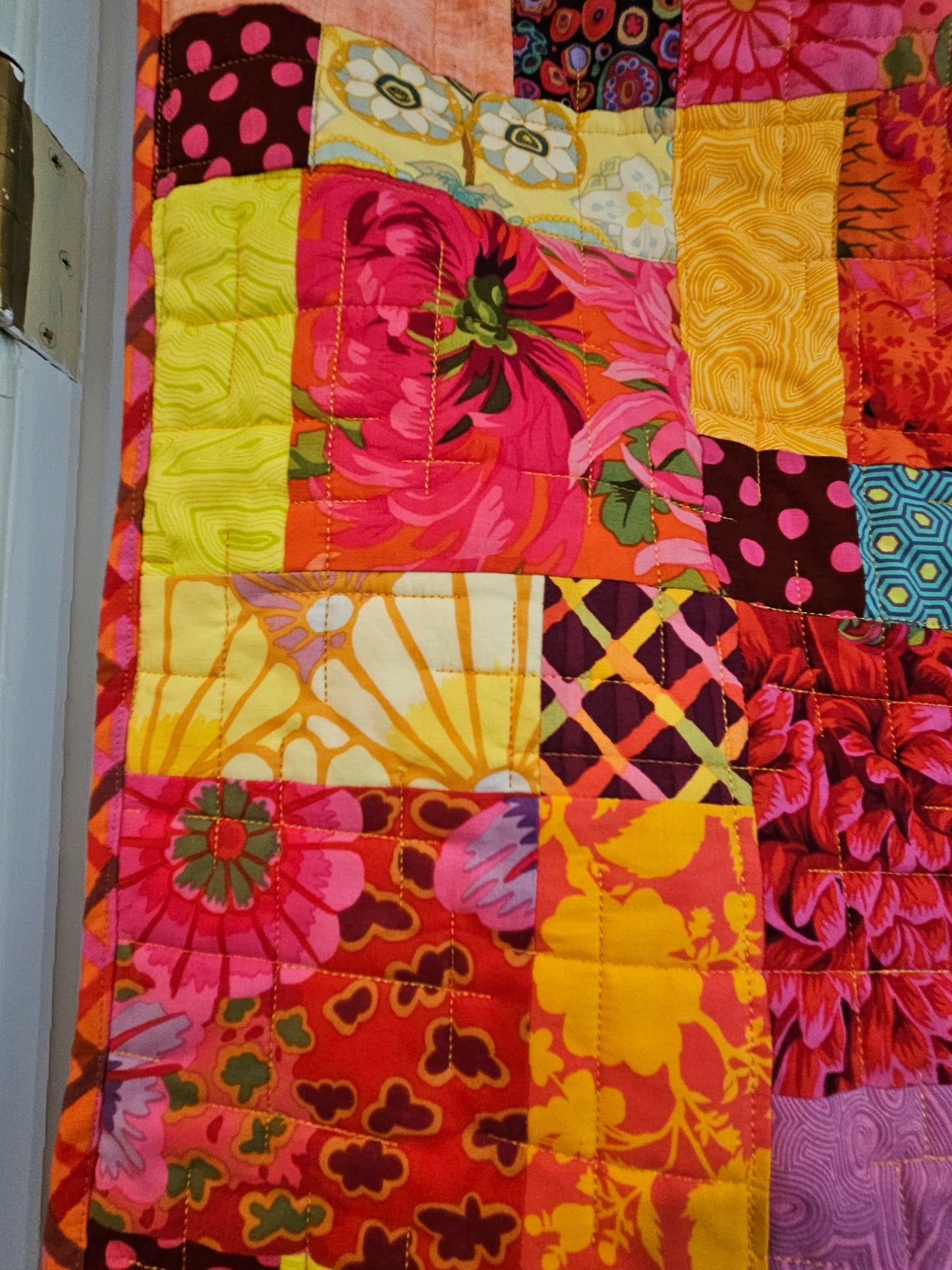 Close up of the Kaffe reds and Tula Pinks fabrics.