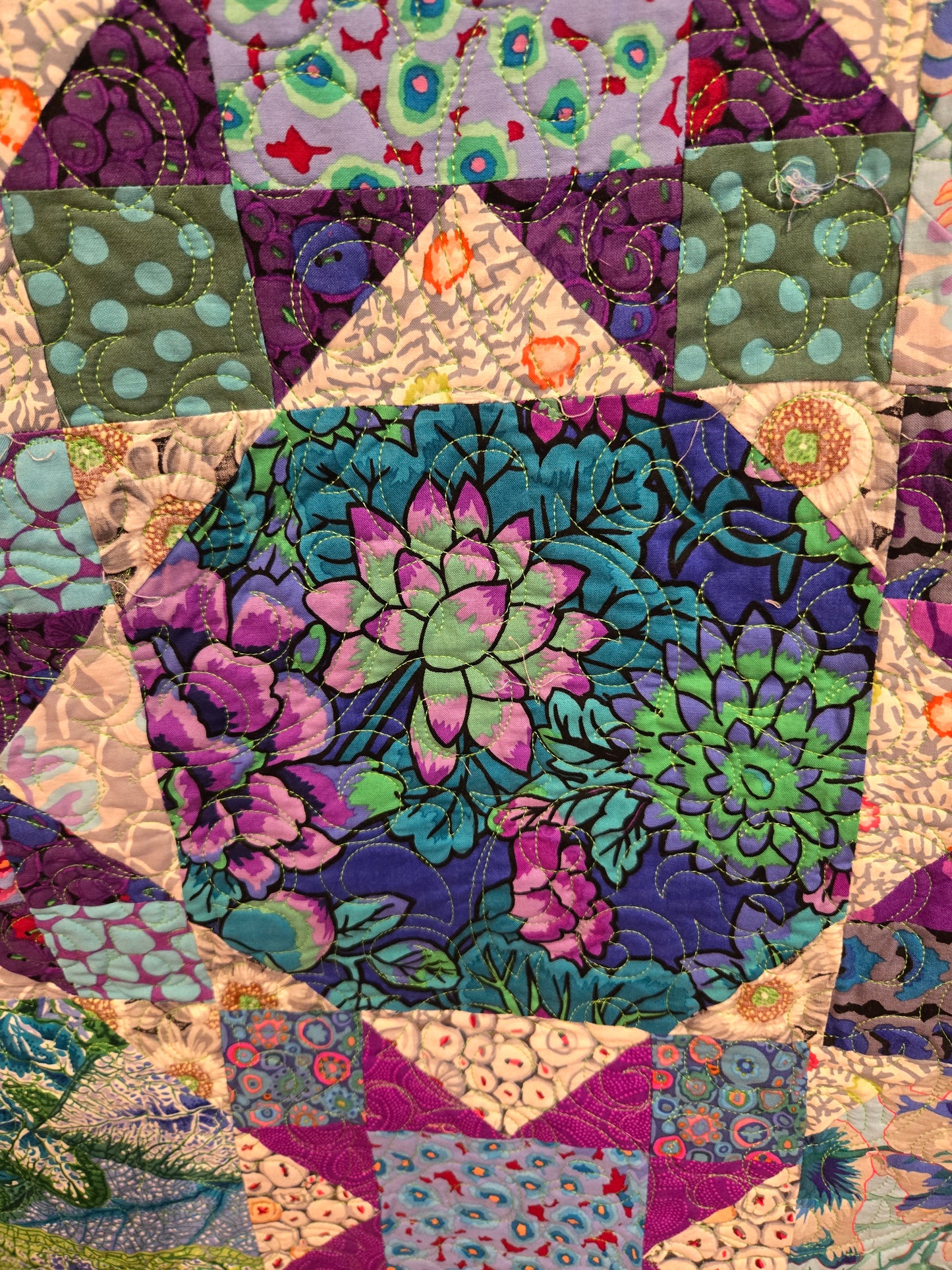 Close up of a snowball block. The corners blend into the adjacent fabric and the middle part appears round when you are farther away.