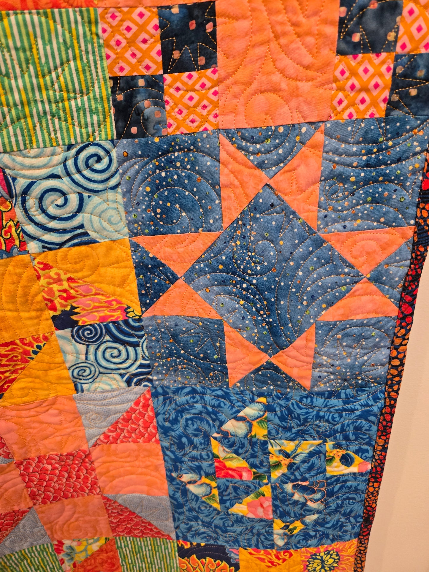 close up of one of the star blocks. Also to see that there is pink and orange in the quilt.