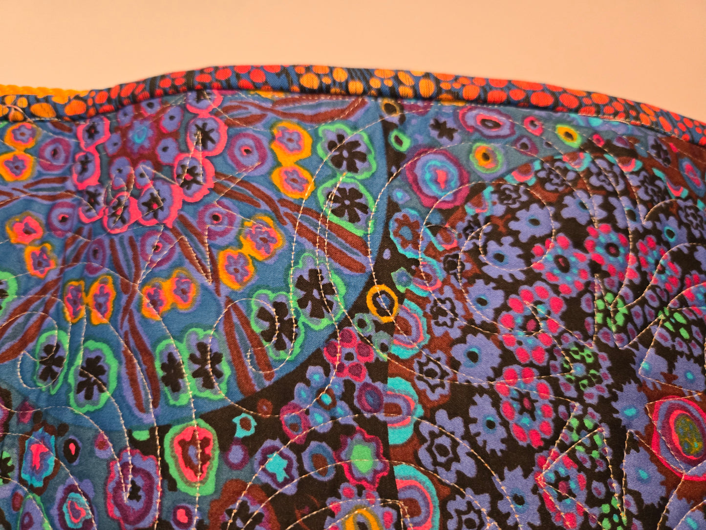 Photo showing some of the West wind quilting pattern and the binding.