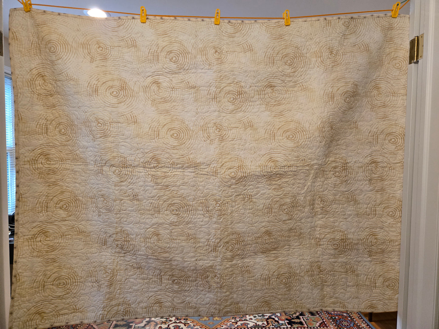 The light color backing with light brown swirls.
