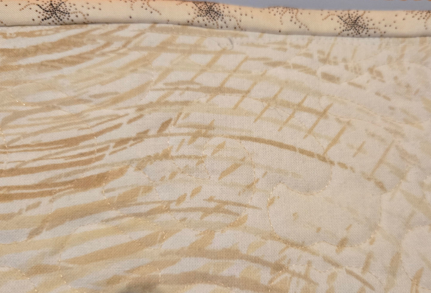 This shows the binding which is a light color with darker brown markings.