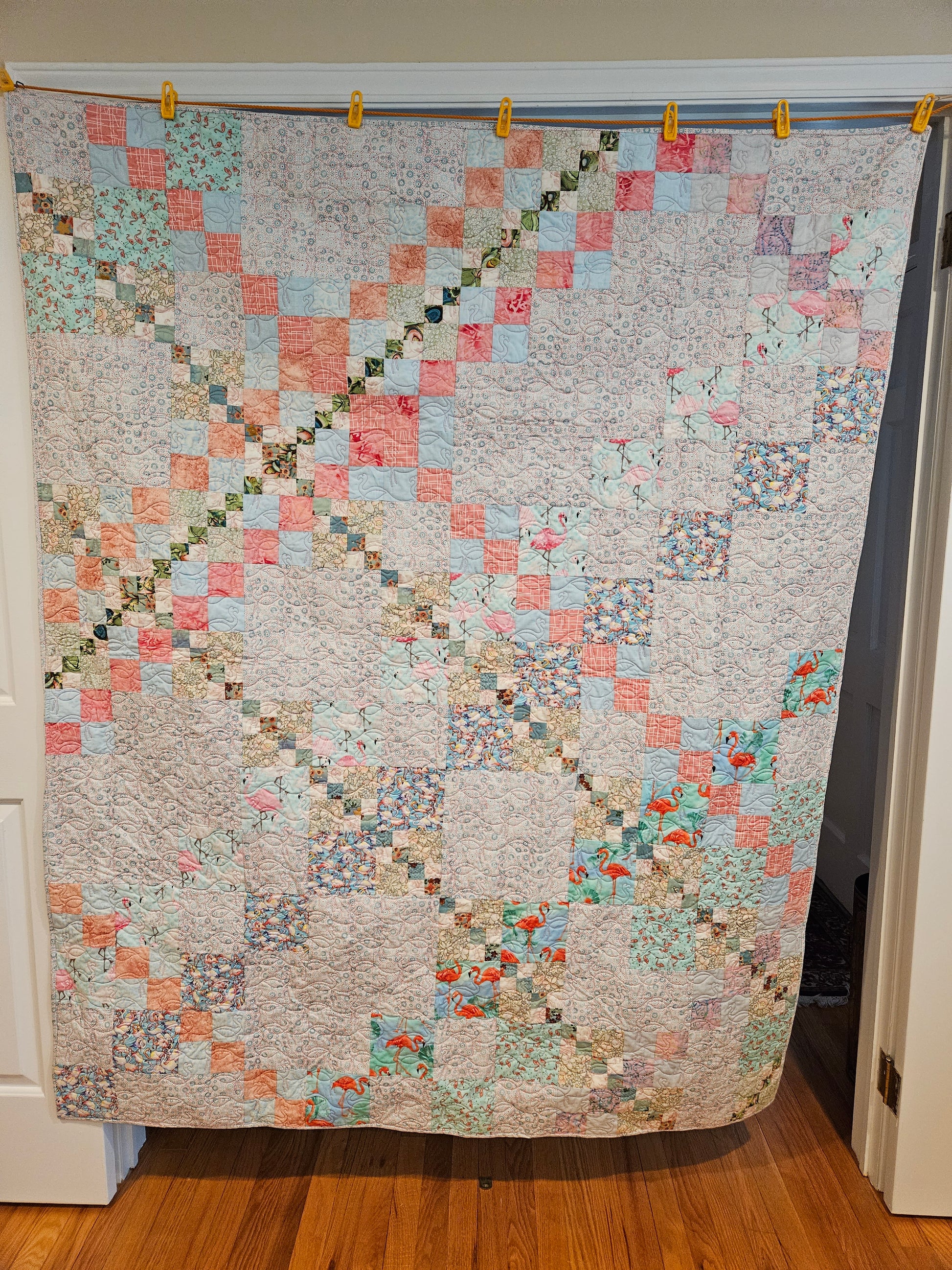 Photo showing the entire front of the blue flamingo quilt.  