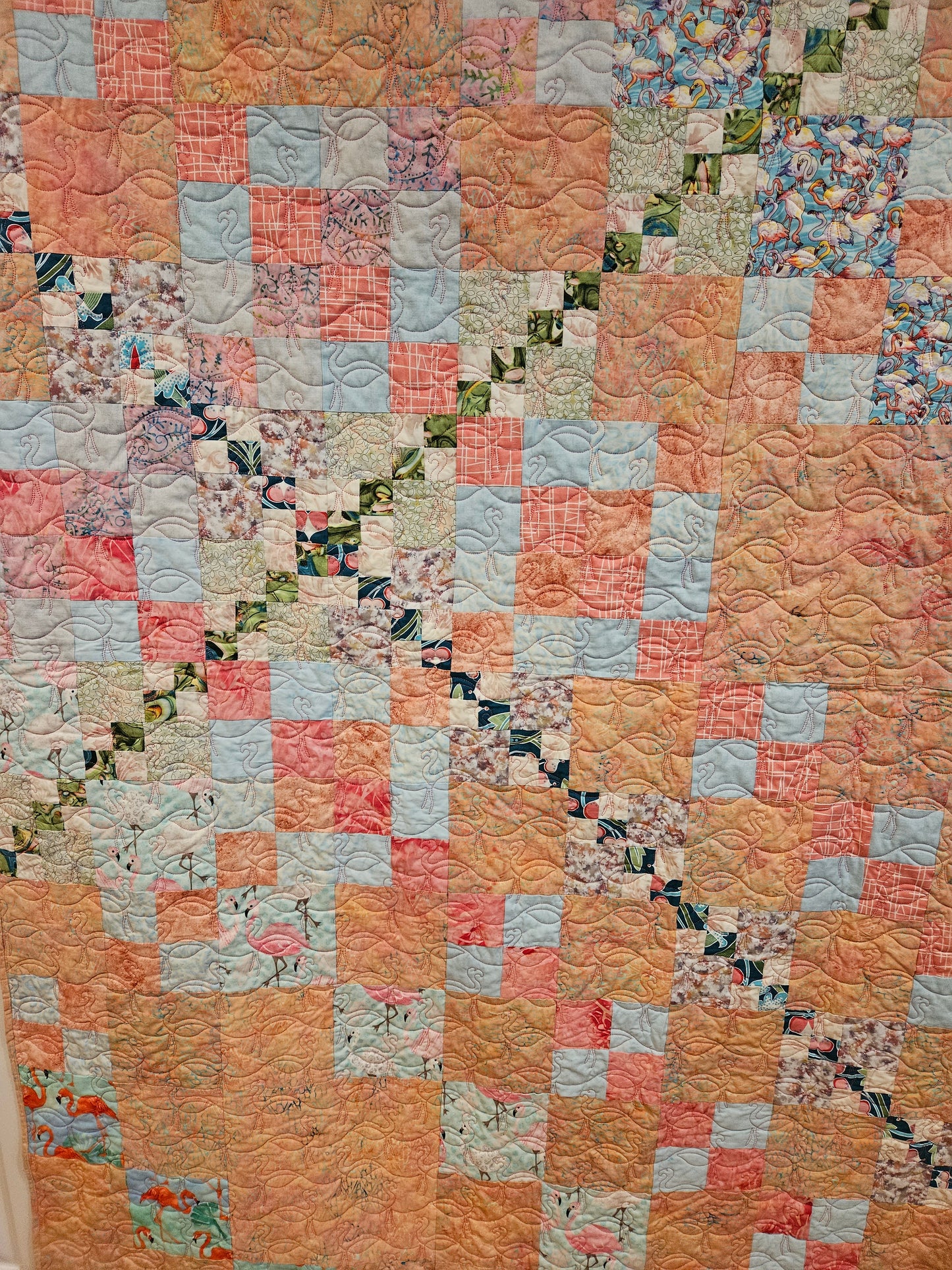 Close up of the crossing point on the pink flamingo quilt.  The flamingo squares are the same in both quilts.  The pink flamingo quilt has alternating pink square.