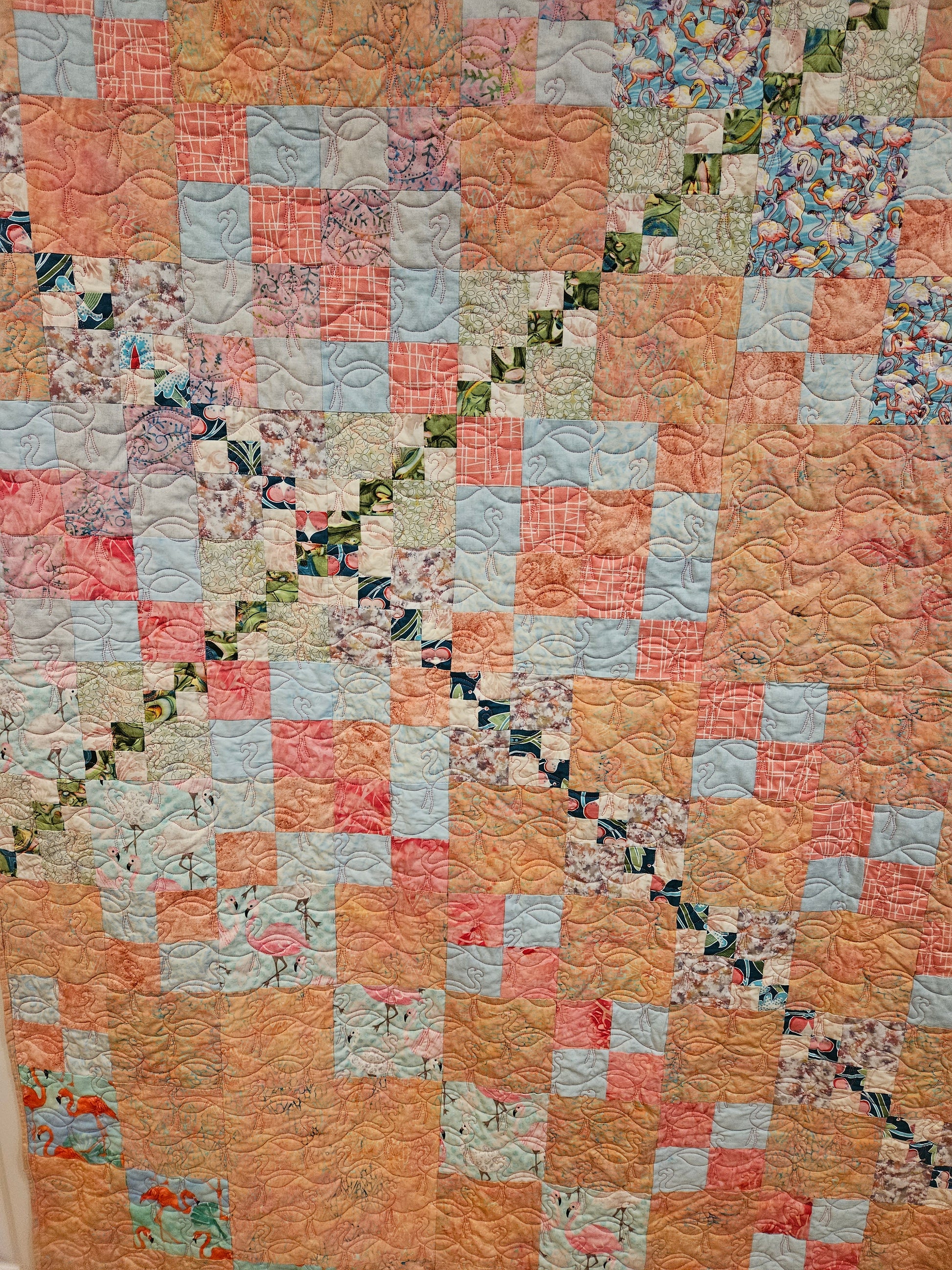 Close up of the crossing point on the pink flamingo quilt.  The flamingo squares are the same in both quilts.  The pink flamingo quilt has alternating pink square.