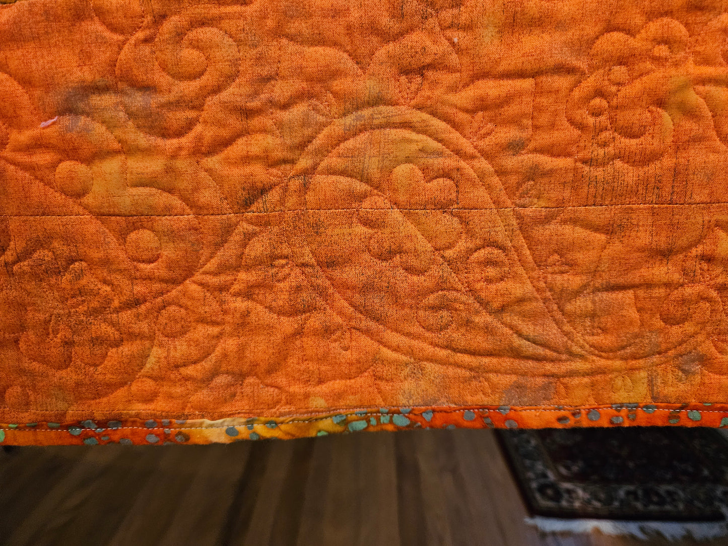 In the orange, where it's a single color, you can see the quilting.