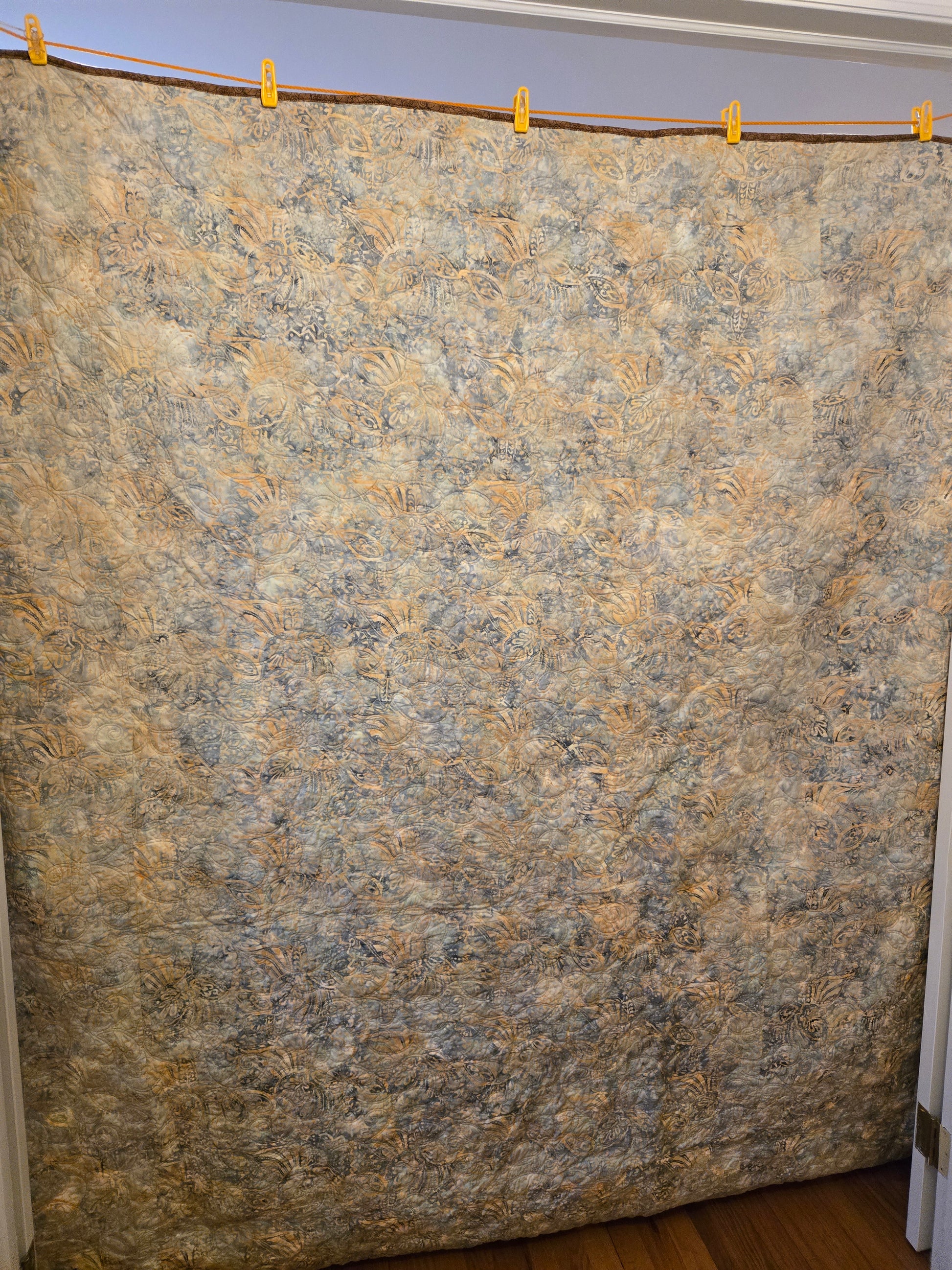 Phot of quilt back.  Pieced of one batik fabrc.