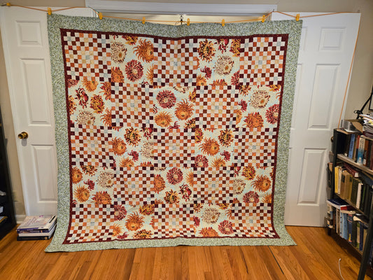 Full view of quilt. Large blocks of mums with alternate pieced blocks. 