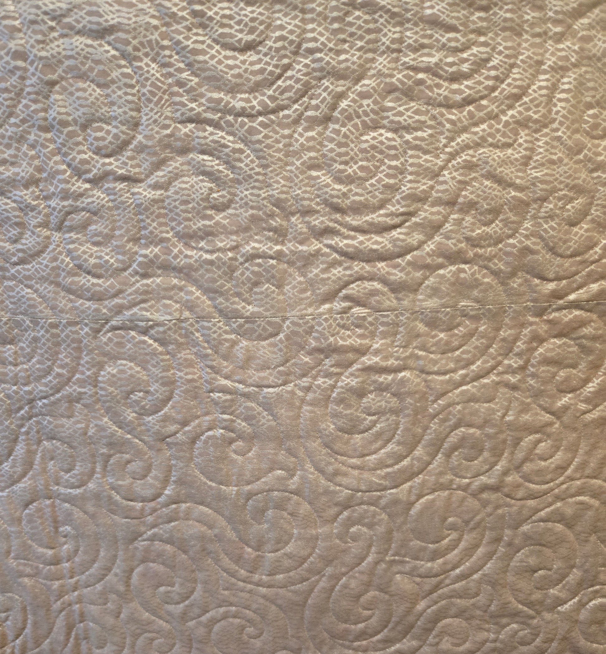 Close up of the back.  It is shiney.  You can see the quilting well.