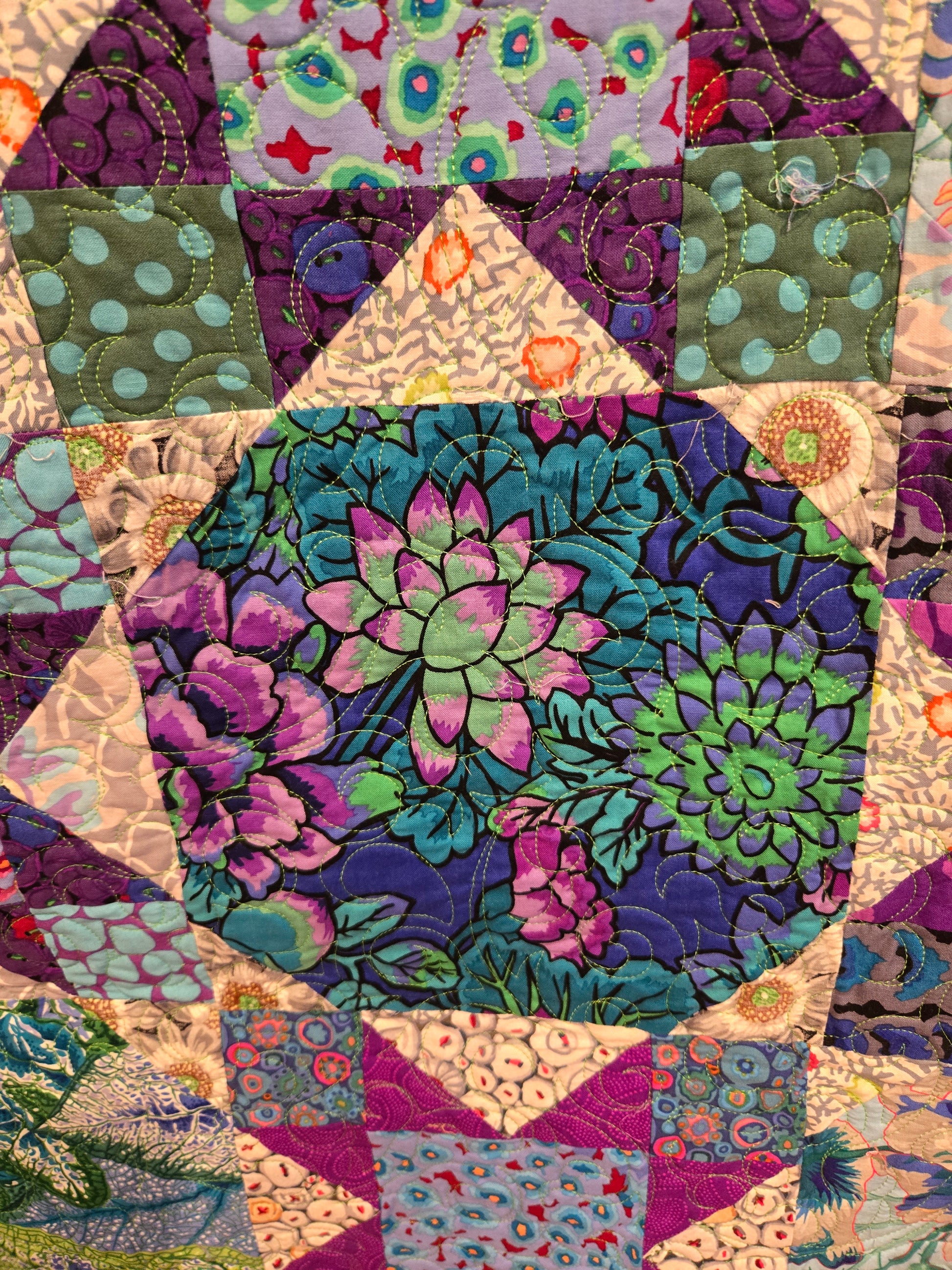 Close up of a snowball block.  The corners blend into the adjacent fabric and the middle part appears round when you are farther away. 