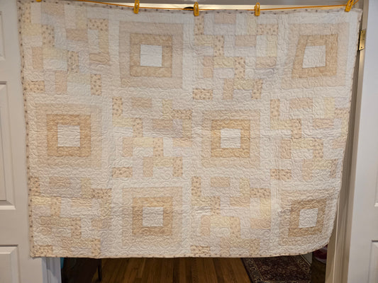 photo showing the entire white/beige quilt. With square in square blocks and rail blocks